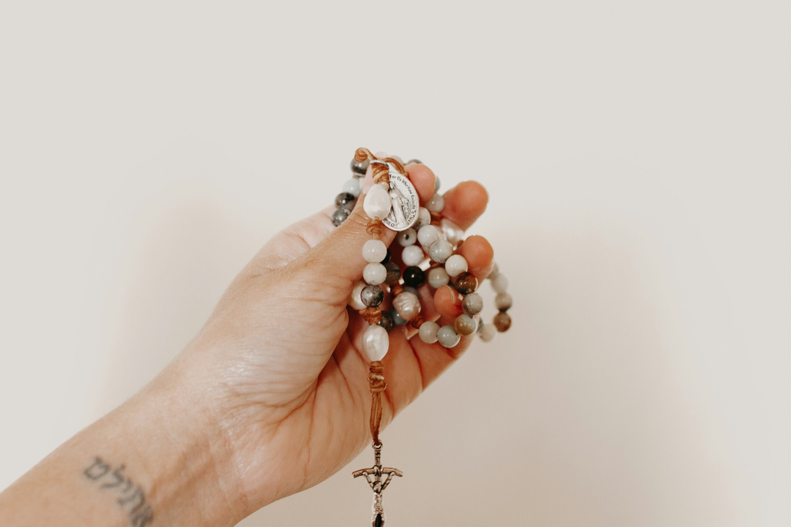 Hand holding a rosary